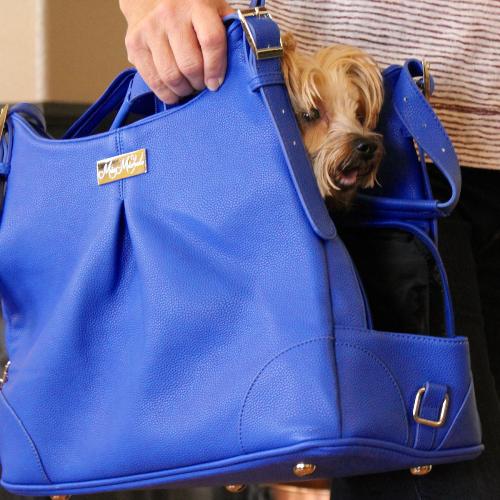 Doggie Design Blue Lapis Mia Michele Carry Bag - Airline Approved. Doggie Design's new Blue Lapis Carry Bag was made to look like a Womans Designer Hand Bag. Now you can take your little Angel with you wherever you go and NO ONE will ever know whats inside your bag. It features High Quality Faux Leather and is lined with Satin Black Waterproof Fabric. Your little Angel will LOVE the super soft plush pillow with removable and washable cover. The inside pillow is covered with waterproof fabric. The Blue Lapis Bag features 2 large pockets for storage. It has plenty of room for your personal items, including your I-Pad or Tablet. Blue Lapis is vented on the top and can be concealed for Privacy.  Includes shoulder strap, leash tether, and has metal feet on the bottom to provide protection to the bag.