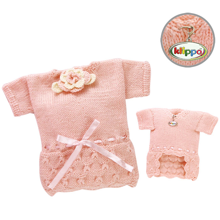 Klippo - Adorable pink hand-knitted sweater with adjustable ribbon intertwined around the waist.  Accented with a crocheted flower at the neckline.  A small D-Ring near the neckline for a "Klippo" charm or ID tag.