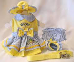 Platinum Puppy Couture - Garden Friends Harness Dress Set - This little yellow with blue gingham harness dress set is precious as well as unique!!  The bodice of the dress is embellished with a beautiful garden daisy and lady bug design.  The skirt has a double ruffle design for extra fullness.  The skirt also has yellow rick-rack trim and cute garden frog embroidery.  This dress has an added D-ring for easy leash access. I t comes with harness dress, matching flip front hat and leash.  It also comes with a darling pair of matching panties.  These are great to use if your little girl is in season or just as part of the outfit.  It also looks darling on those dogs with a slightly longer body (if dresses are usually too short).