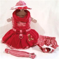 Platnum Puppy Couture - Gingerbread Girl Jumper Style 4-pc Harness Dress Set - This Gingerbread Girl dog dress set is absolutely beautiful! It is made with a red and white gingham print and red velveteen fabric. It has a double ruffle design. There is a sweet gingerbread girl embroidery design on the right side of the skirt. This dog dress has an added D-ring for easy leash access. The set includes harness dress, panty, hat, and matching leash. The panty is great to use if your pet is in season or just as part of the outfit. It also looks darling on those dogs with a slightly longer body (if dresses are usually too short). High quality...all pieces are lined and finished.