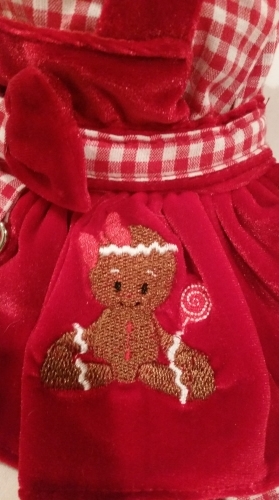 Platinum Puppy Couture - Gingerbread Girl Jumper Style Velveteen 4pc Harness Dress Set - This Gingerbread Girl dog dress set is absolutely beautiful! It is made with a red and white gingham print and red velveteen fabric. It has a double ruffle design. There is a sweet gingerbread girl embroidery design on the right side of the skirt. This dog dress has an added D-ring for easy leash access. The set includes harness dress, panty, hat, and matching leash. The panty is great to use if your pet is in season or just as part of the outfit. It also looks darling on those dogs with a slightly longer body (if dresses are usually too short). High quality...all pieces are lined and finished.