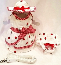 Platinum Puppy Couture - Strawberries & Cream - This white and red gingham-trimmed printed harness dress set is just precious!!  The white fabric is embellished with cute red strawberries and dots.  The skirt has a side ruffle design with a contrasting gingham trim and bow.  It has an added D-ring for easy leash access.  This 4-piece set includes a harness dress, matching sun hat, panty and leash.  The darling matching panty is great to use if your pet is in season or just as part of the outfit.  It also looks darling on those dogs with a slightly longer body (if dresses are usually too short).